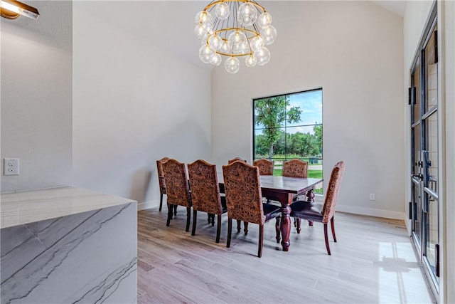 dining space featuring an inviting chandelier and light hardwood / wood-style floors