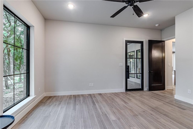 spare room featuring light hardwood / wood-style floors and ceiling fan