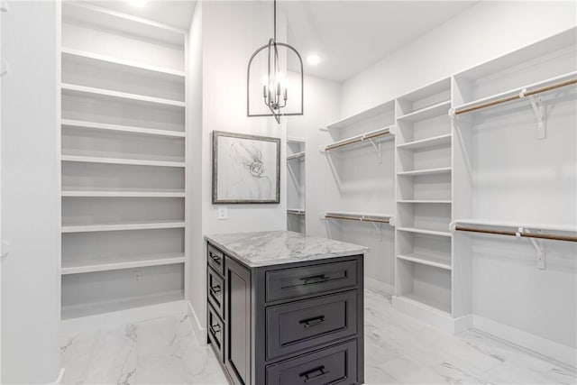 spacious closet with a chandelier