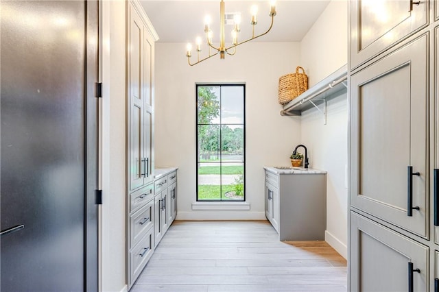 interior space with a notable chandelier and light hardwood / wood-style flooring