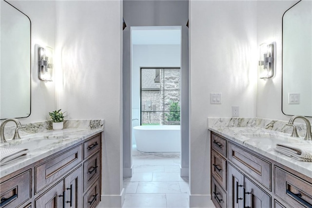 bathroom featuring vanity and a washtub