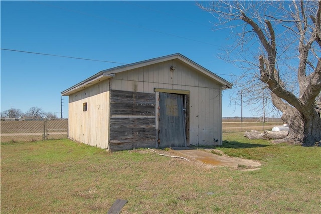 view of outbuilding with an outbuilding and fence