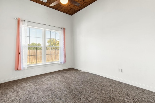 carpeted empty room featuring ceiling fan, wood ceiling, and vaulted ceiling