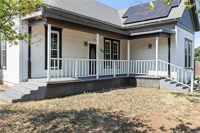 view of front of house with solar panels and covered porch