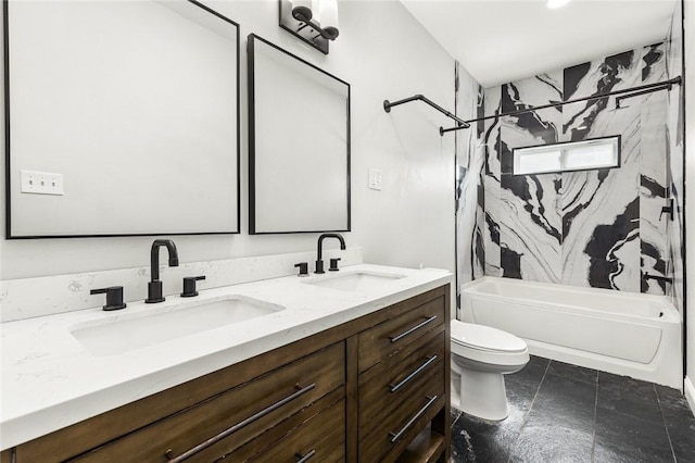 full bathroom with vanity, tiled shower / bath combo, and toilet