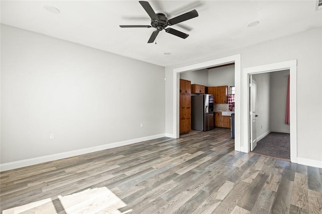 unfurnished living room featuring ceiling fan and light hardwood / wood-style flooring