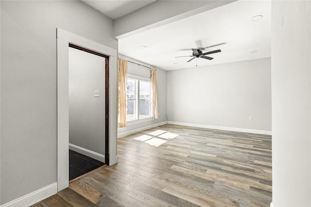 empty room featuring hardwood / wood-style floors and ceiling fan