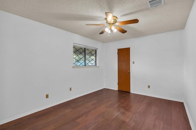 unfurnished room featuring a textured ceiling, dark hardwood / wood-style floors, and ceiling fan