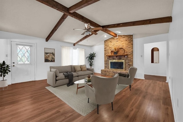 living room featuring dark hardwood / wood-style floors, a healthy amount of sunlight, and lofted ceiling with beams