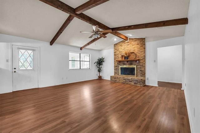 unfurnished living room featuring lofted ceiling with beams, ceiling fan, wood-type flooring, and a fireplace