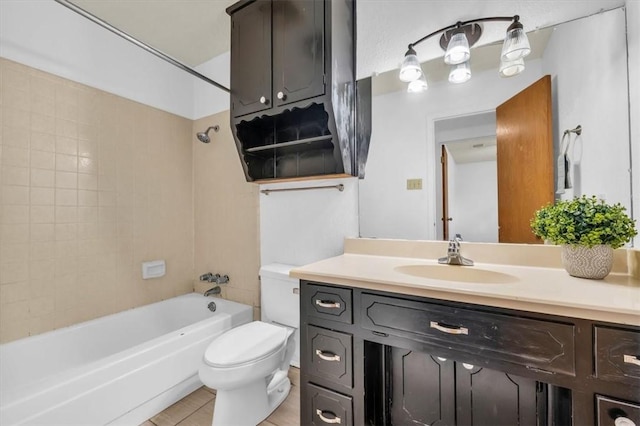 full bathroom with tile patterned flooring, vanity, tiled shower / bath combo, and toilet