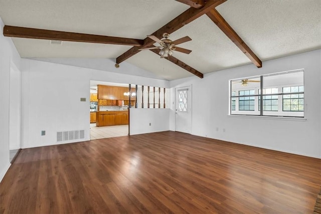 unfurnished living room featuring lofted ceiling with beams, a textured ceiling, ceiling fan with notable chandelier, and light hardwood / wood-style flooring