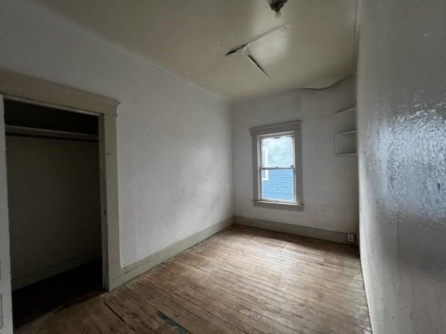 unfurnished bedroom featuring hardwood / wood-style flooring