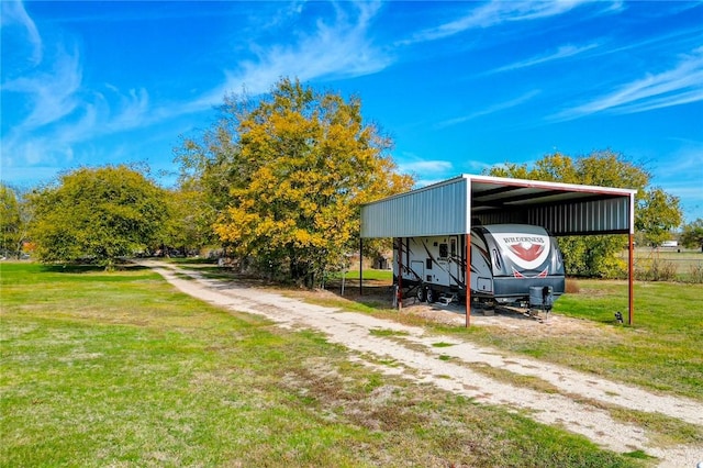 view of outbuilding with a lawn and a carport