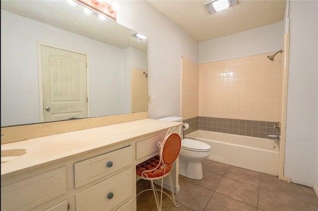 full bathroom featuring tile patterned floors, vanity, a textured ceiling, and tiled shower / bath combo