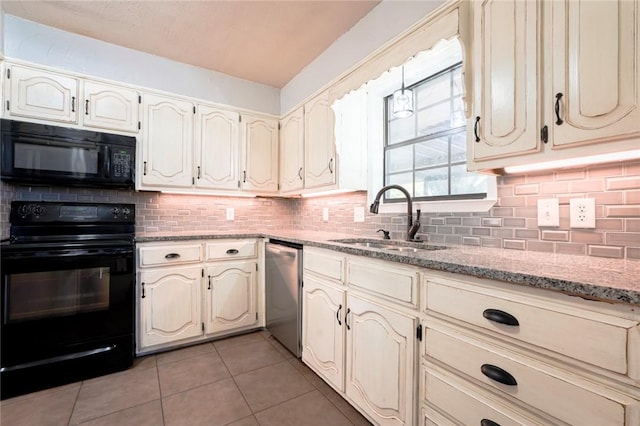 kitchen featuring light stone countertops, sink, tasteful backsplash, light tile patterned flooring, and black appliances