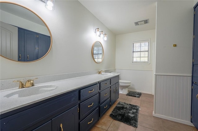 bathroom featuring tile patterned floors, vanity, and toilet