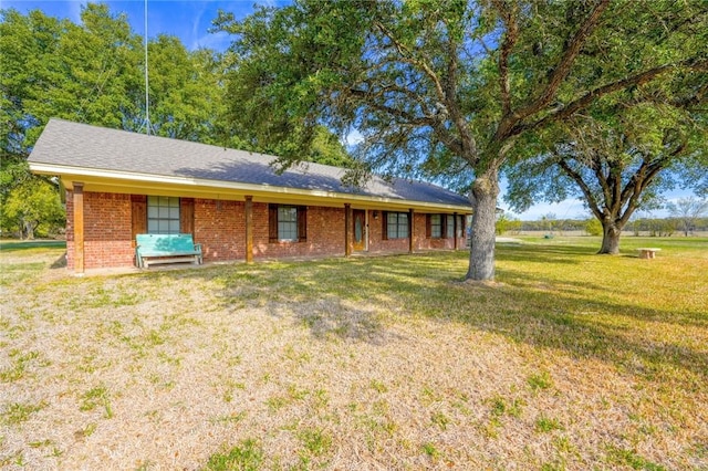 ranch-style home featuring a front yard