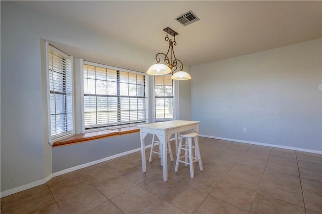 unfurnished dining area featuring light tile patterned floors and a notable chandelier