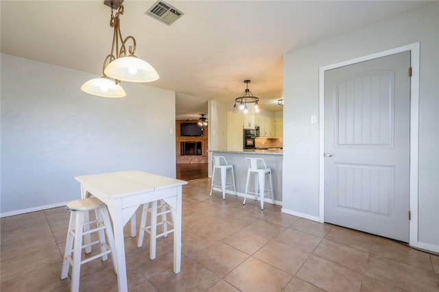 dining room featuring a notable chandelier and light tile patterned flooring