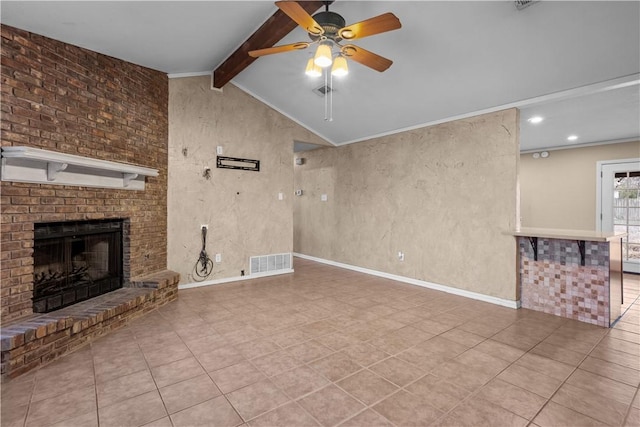 unfurnished living room with lofted ceiling with beams, a fireplace, visible vents, baseboards, and ornamental molding