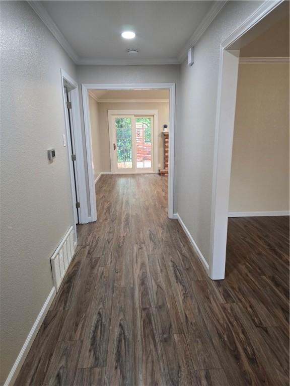 corridor with crown molding and dark hardwood / wood-style floors