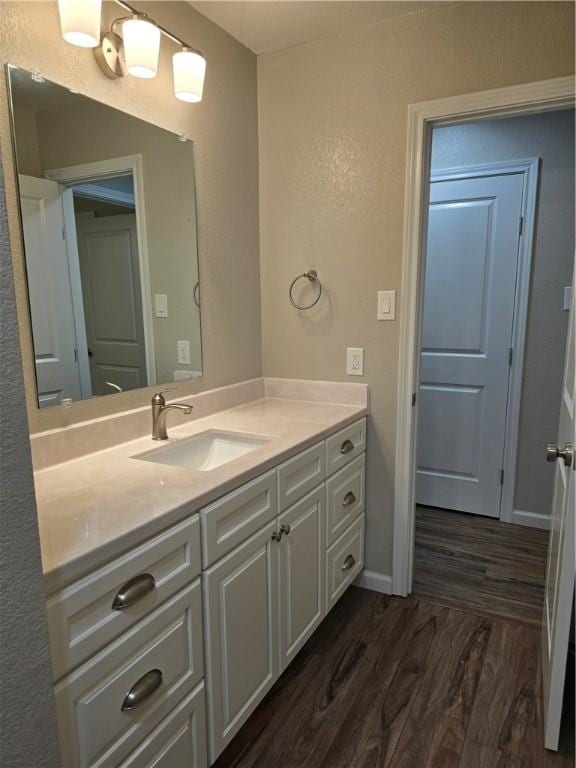 bathroom with hardwood / wood-style floors and vanity