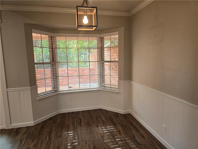 unfurnished dining area with dark hardwood / wood-style flooring, plenty of natural light, and ornamental molding