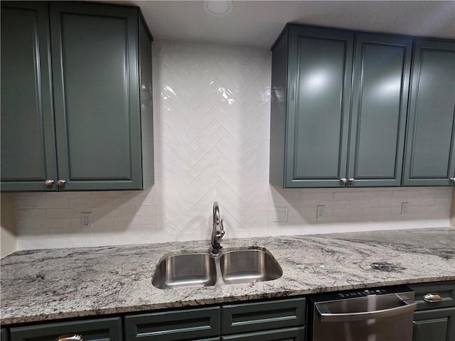 kitchen featuring decorative backsplash, light stone counters, dishwasher, and sink