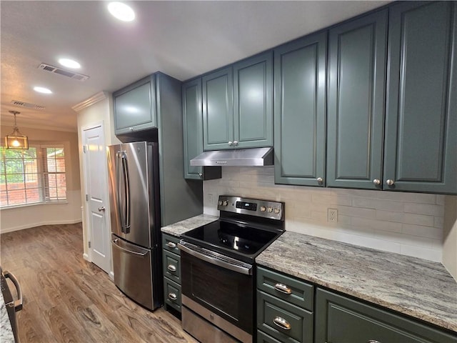 kitchen with light stone countertops, tasteful backsplash, light hardwood / wood-style flooring, lofted ceiling, and appliances with stainless steel finishes