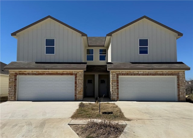 view of front of house featuring an attached garage, board and batten siding, and concrete driveway