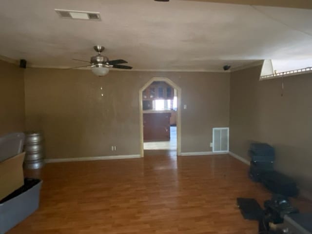 unfurnished living room with hardwood / wood-style flooring and ceiling fan