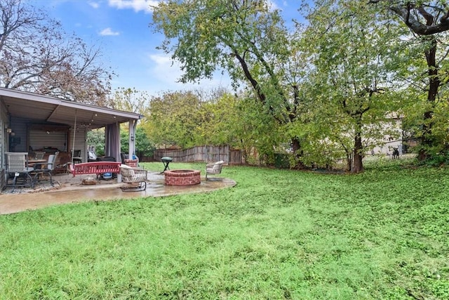 view of yard featuring a fire pit and a patio