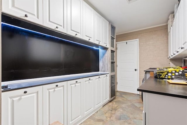 kitchen featuring white cabinetry and ornamental molding