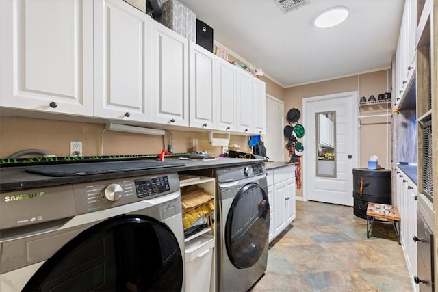 laundry area featuring cabinets, washer and clothes dryer, and crown molding