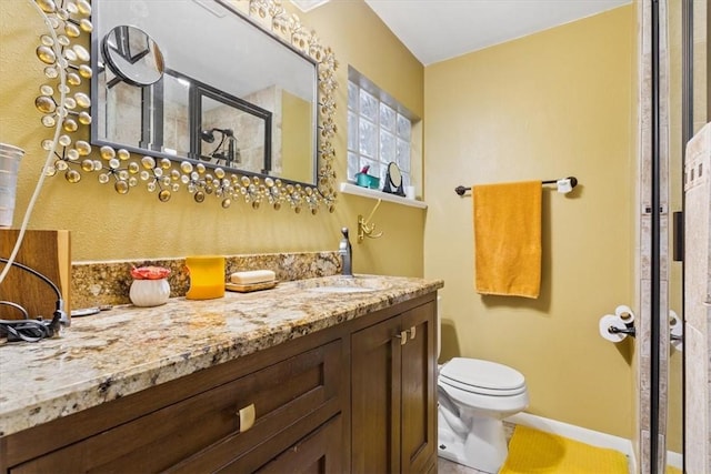 bathroom featuring tile patterned floors, vanity, toilet, and a shower with shower door