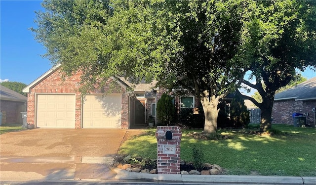 view of property hidden behind natural elements featuring a front yard and a garage