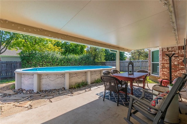 view of patio / terrace with a fenced in pool