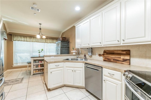 kitchen with white cabinets, sink, tasteful backsplash, kitchen peninsula, and stainless steel appliances