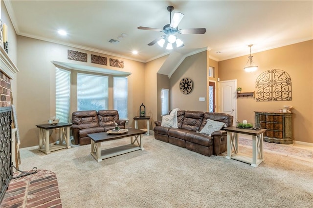 living room featuring ceiling fan, carpet floors, crown molding, and a brick fireplace