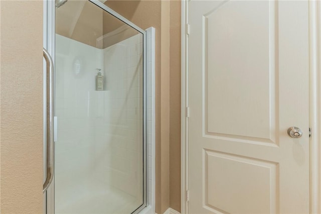 bathroom with a shower with shower door