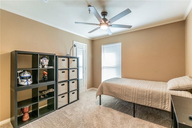 bedroom featuring ceiling fan, crown molding, and carpet floors