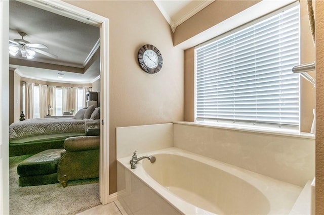 bathroom featuring a bathing tub, ceiling fan, crown molding, and tile patterned flooring