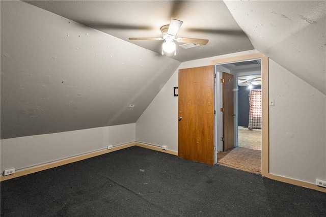 additional living space with ceiling fan, carpet, and vaulted ceiling