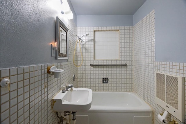 bathroom featuring sink, tile walls, and heating unit