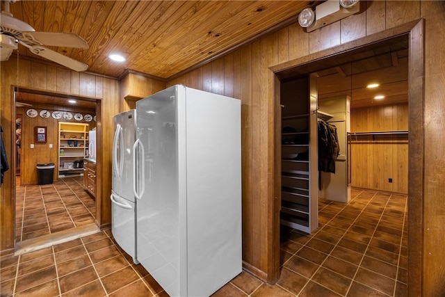 kitchen with stainless steel fridge, ceiling fan, white refrigerator, wooden ceiling, and wood walls