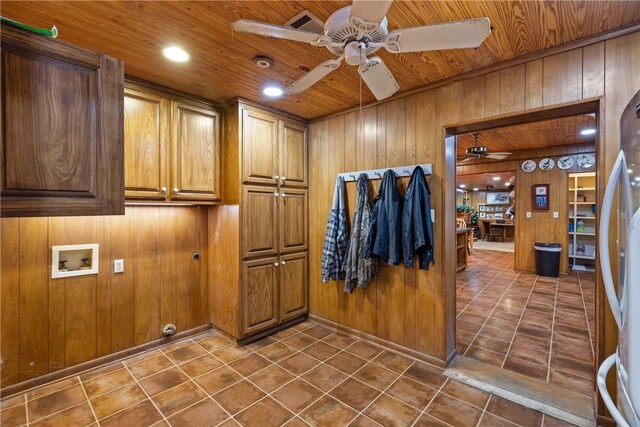 washroom with cabinets, wooden ceiling, hookup for a washing machine, wooden walls, and ceiling fan