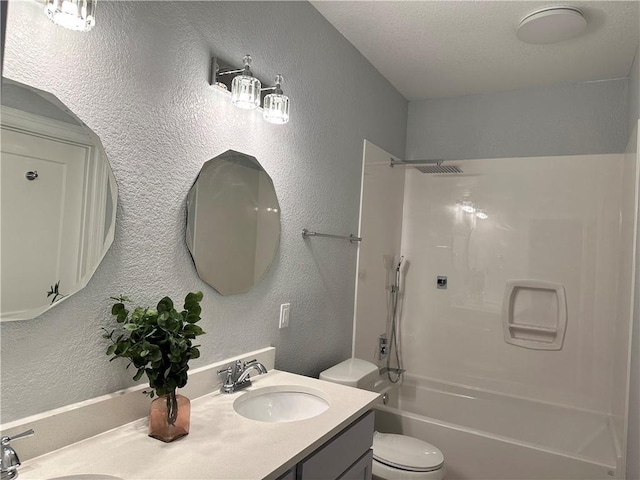 full bathroom featuring double vanity, toilet, a textured wall, and a sink