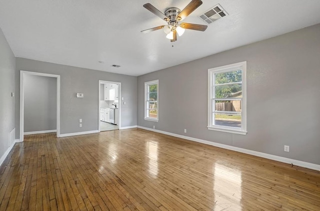 interior space featuring light hardwood / wood-style flooring, ceiling fan, and plenty of natural light