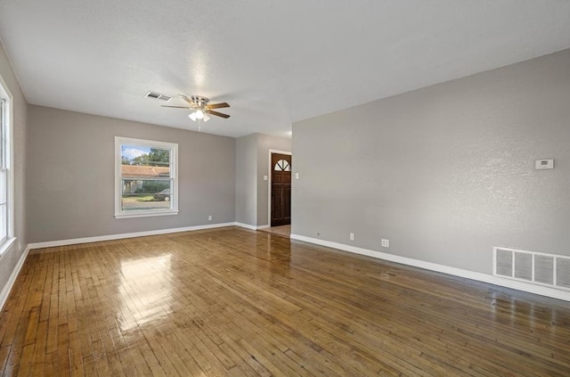 spare room featuring dark hardwood / wood-style floors and ceiling fan